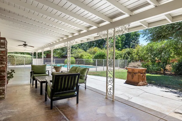 a view of a house with swimming pool and porch