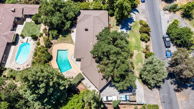 a view of a house with swimming pool and a yard
