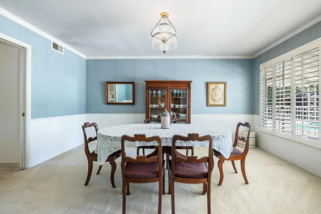 a dining room with furniture and window