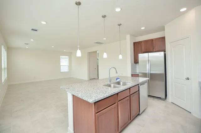a kitchen with stainless steel appliances granite countertop a sink a stove and a microwave