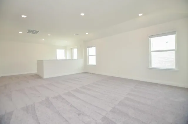 an empty room with windows and closet