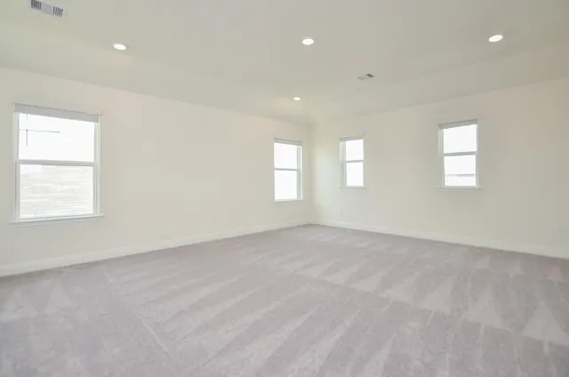 an empty room with windows and closet