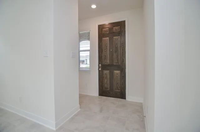 an empty room with windows and closet