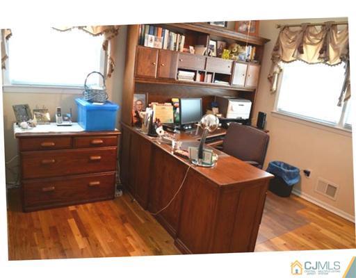 4 Butler Road Edison, NJ 08820 - Photo 22 of 25 a living room with a dresser and a window