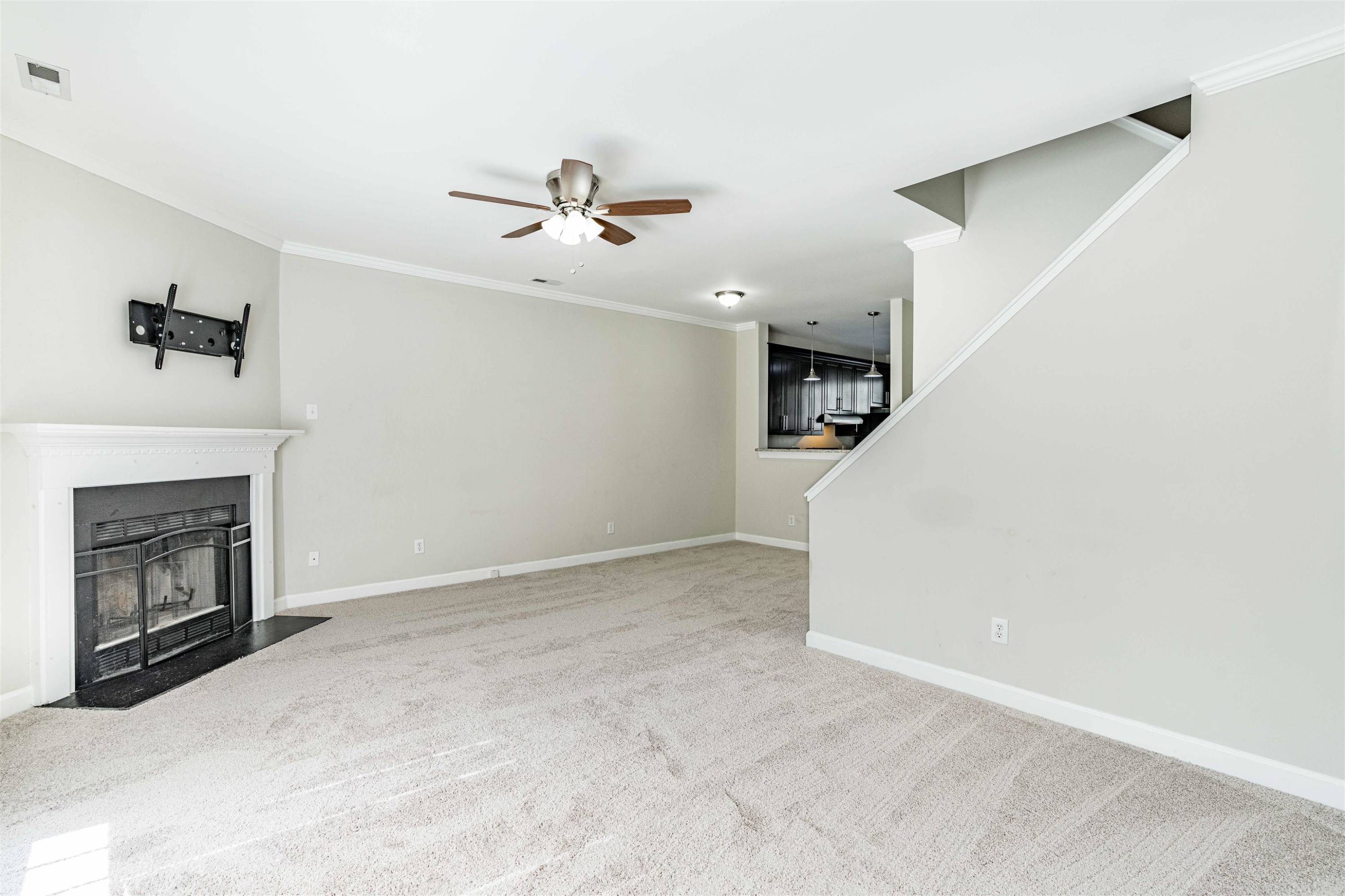 807 Rothshire Court Raleigh, NC 27615 - Photo 13 of 25 a view of a livingroom with a fireplace and ceiling fan