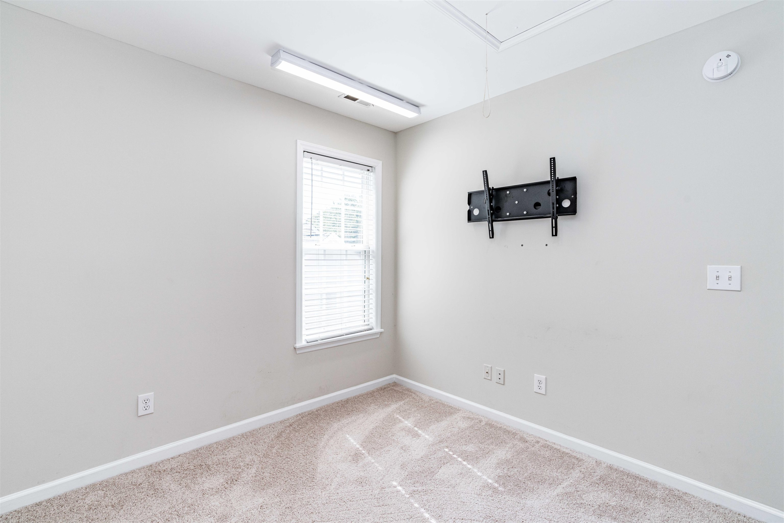 807 Rothshire Court Raleigh, NC 27615 - Photo 21 of 25 an empty room with windows and cabinet