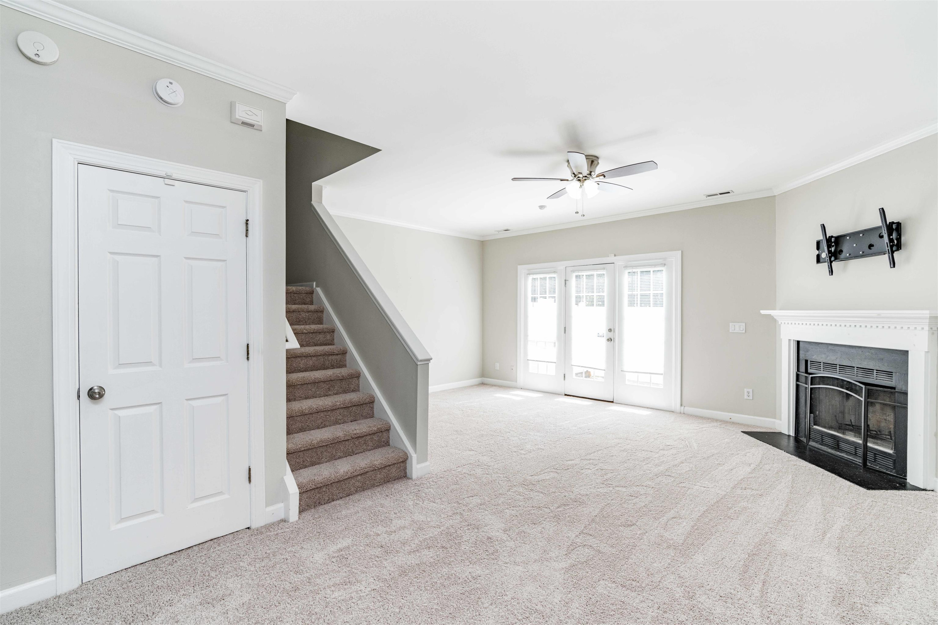 807 Rothshire Court Raleigh, NC 27615 - Photo 9 of 25 a view of an empty room with a fireplace and a window