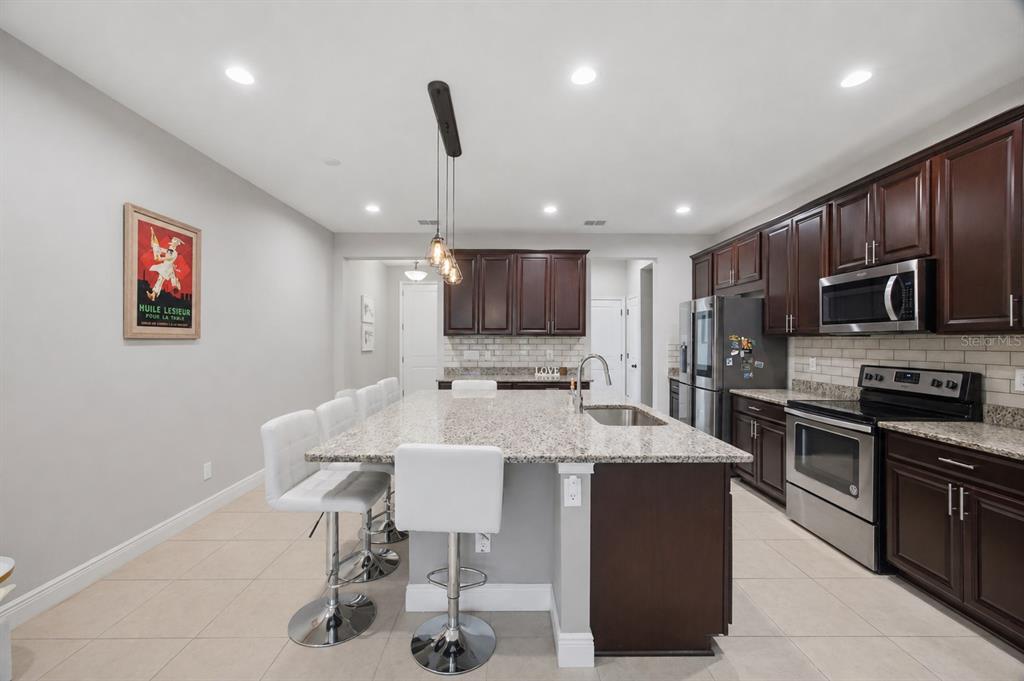 2013 Sunset Wind Loop Oldsmar, FL 34677 - Photo 7 of 43 a large kitchen with a table and chairs