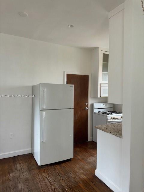 439 15th Street, Unit 9 Miami Beach, FL 33139 - Photo 8 of 11 a kitchen with a refrigerator sink stove and cabinets
