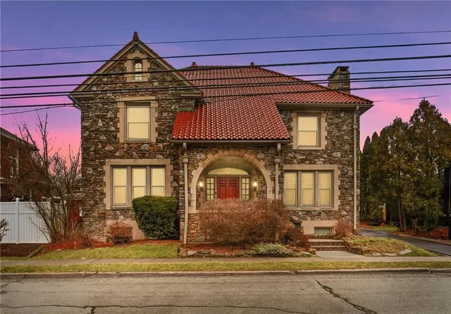 a front view of a house with garden