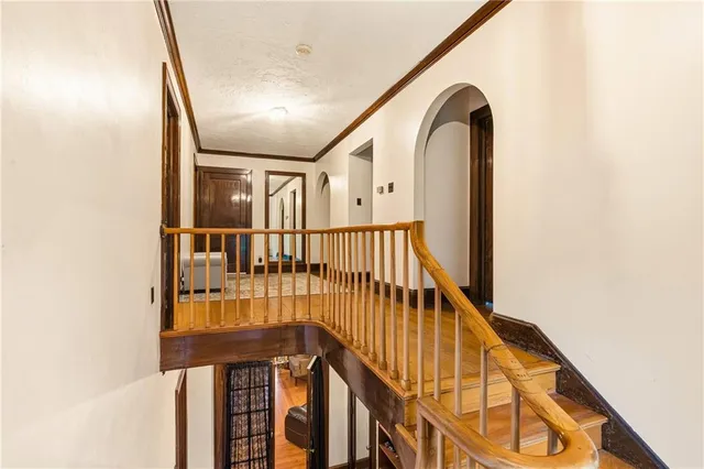 a view of staircase with railing and white walls