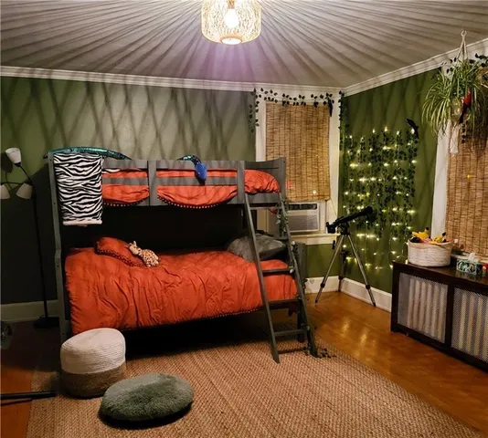 a bed sitting in a bedroom next to a window