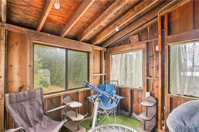 a reading room with furniture and a rug