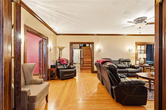 a living room with furniture and a chandelier