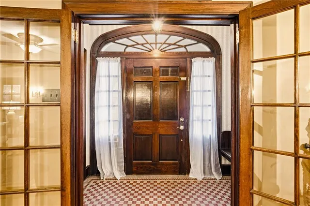 a view of entryway with a front door and wooden floor