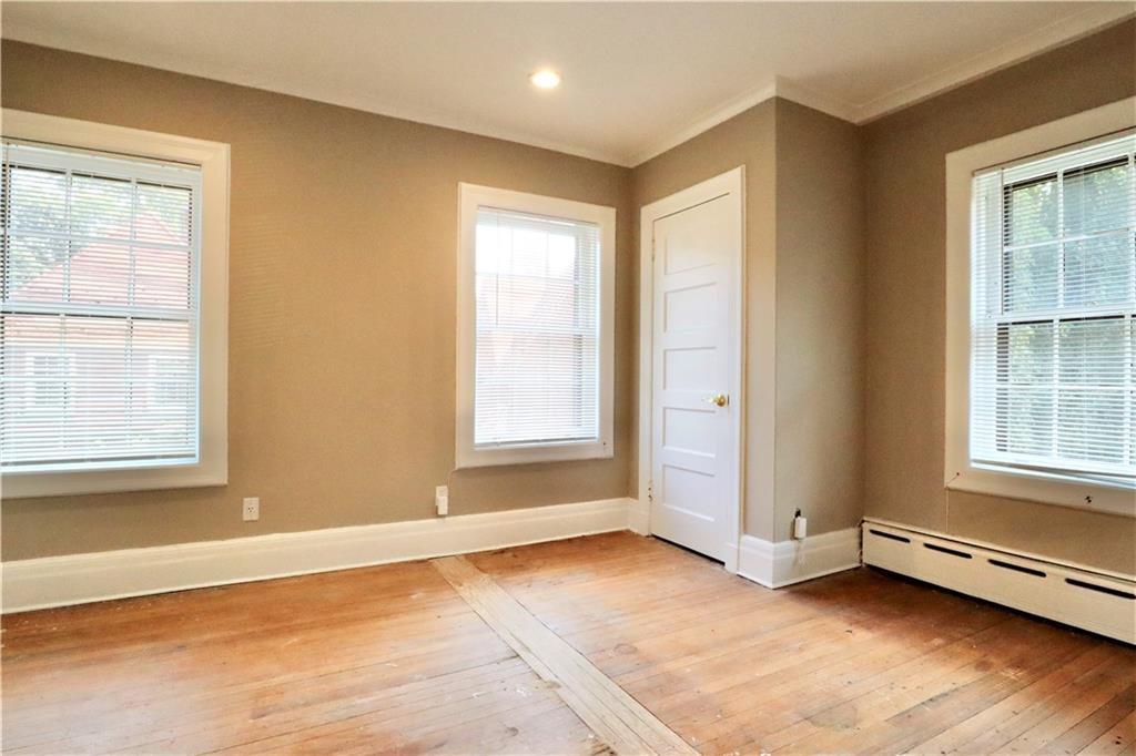 24 Wendover Road Queens, NY 11375 - Photo 18 of 34 an empty room with wooden floor and windows