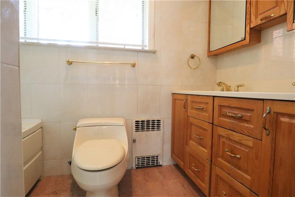 24 Wendover Road Queens, NY 11375 - Photo 20 of 34 a bathroom with a toilet and a sink