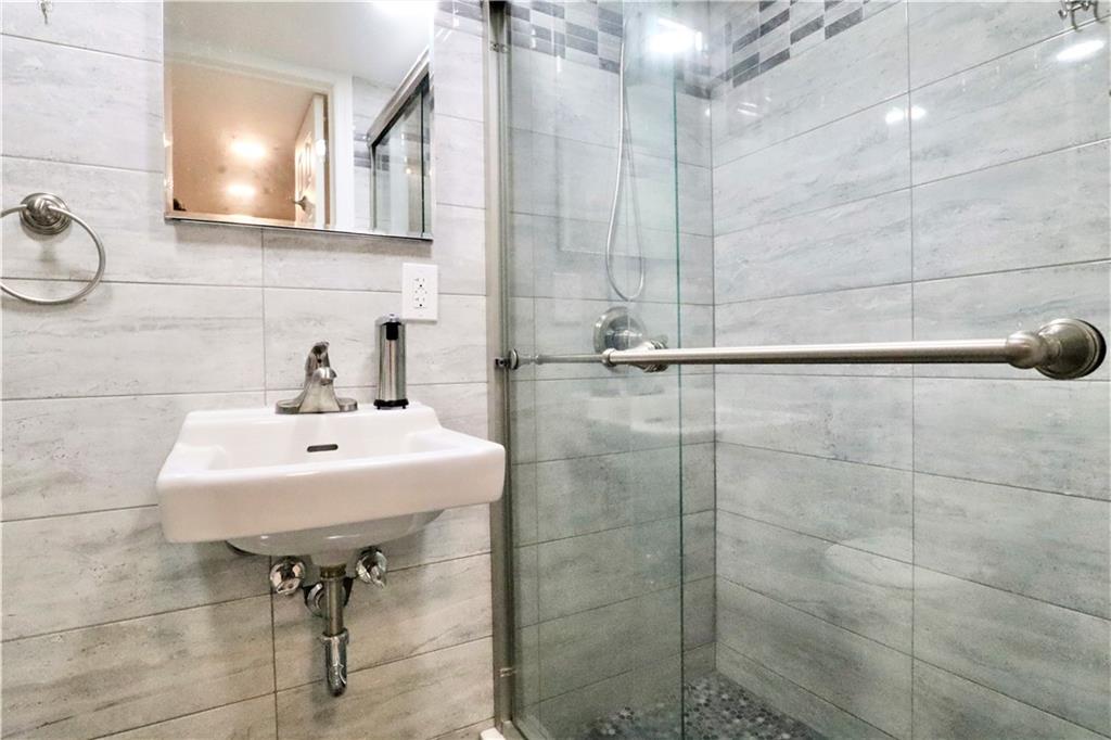 24 Wendover Road Queens, NY 11375 - Photo 23 of 34 a bathroom with a sink a toilet and shower
