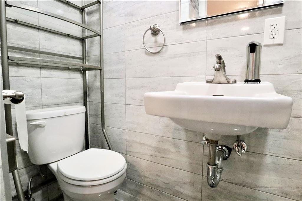 24 Wendover Road Queens, NY 11375 - Photo 24 of 34 a bathroom with a toilet and a sink