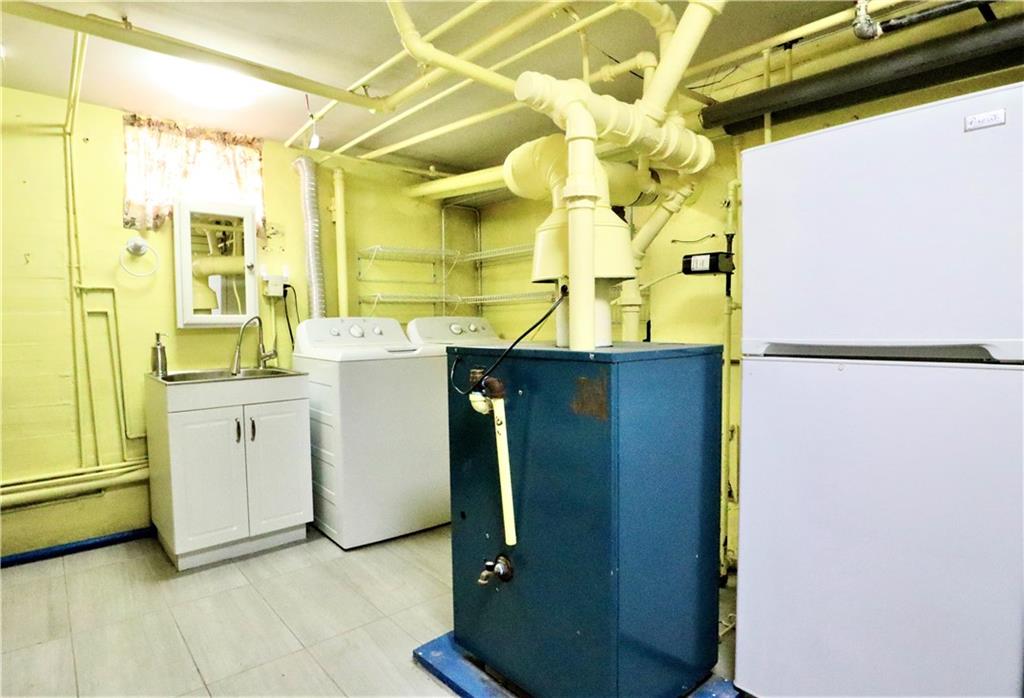 24 Wendover Road Queens, NY 11375 - Photo 25 of 34 a utility room with dryer and washer