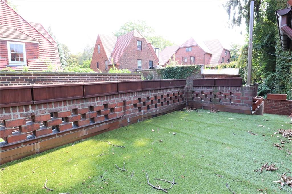 24 Wendover Road Queens, NY 11375 - Photo 30 of 34 a view of a house with a backyard and a patio