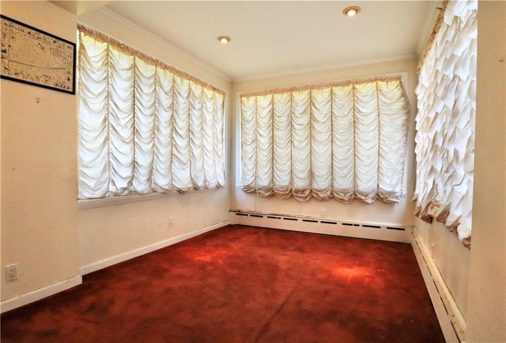 24 Wendover Road Queens, NY 11375 - Photo 6 of 34 a view of an empty room with a window and wooden floor