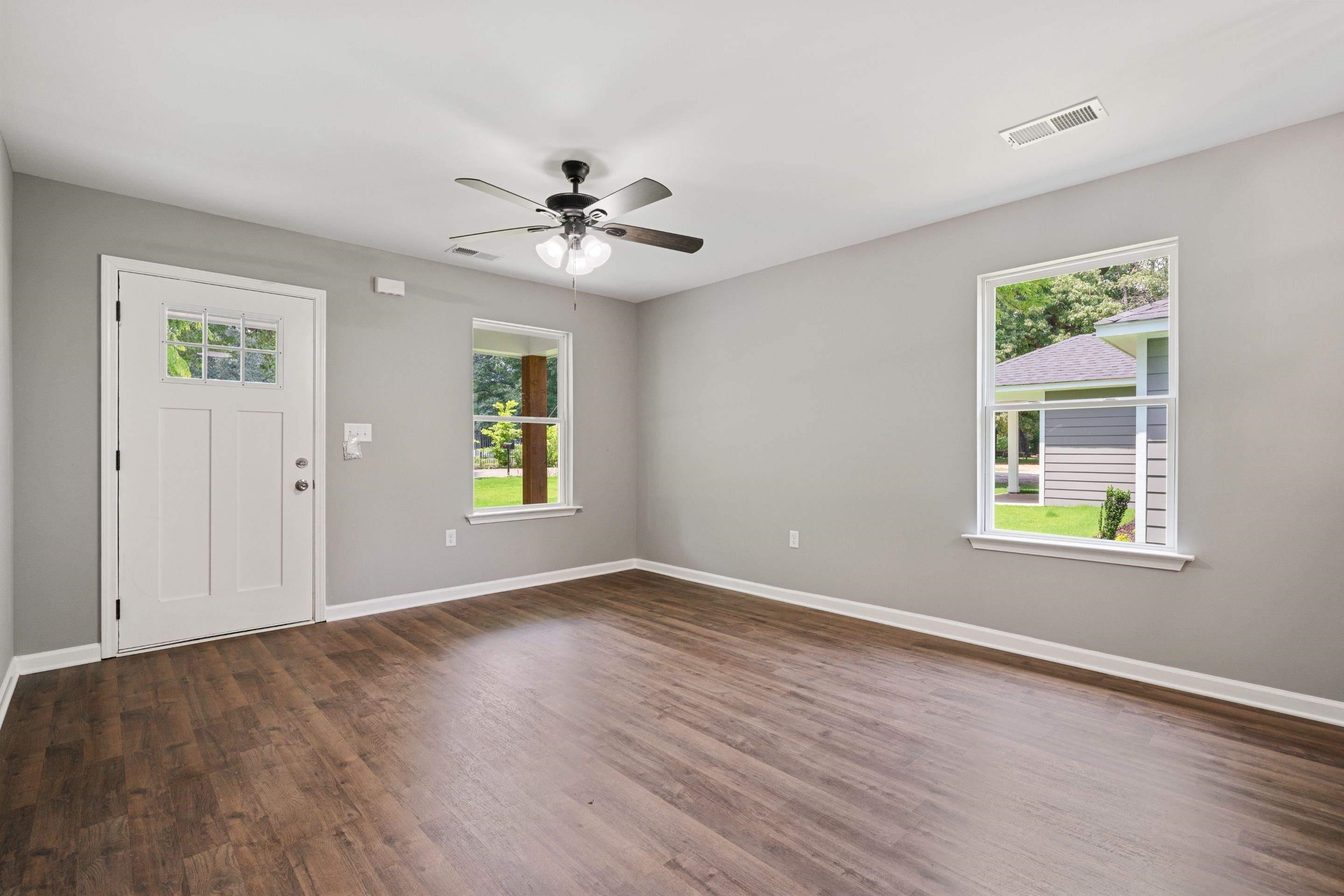 3766 Grey Road Memphis, TN 38108 - Photo 5 of 12 a view of an empty room with a window and wooden floor