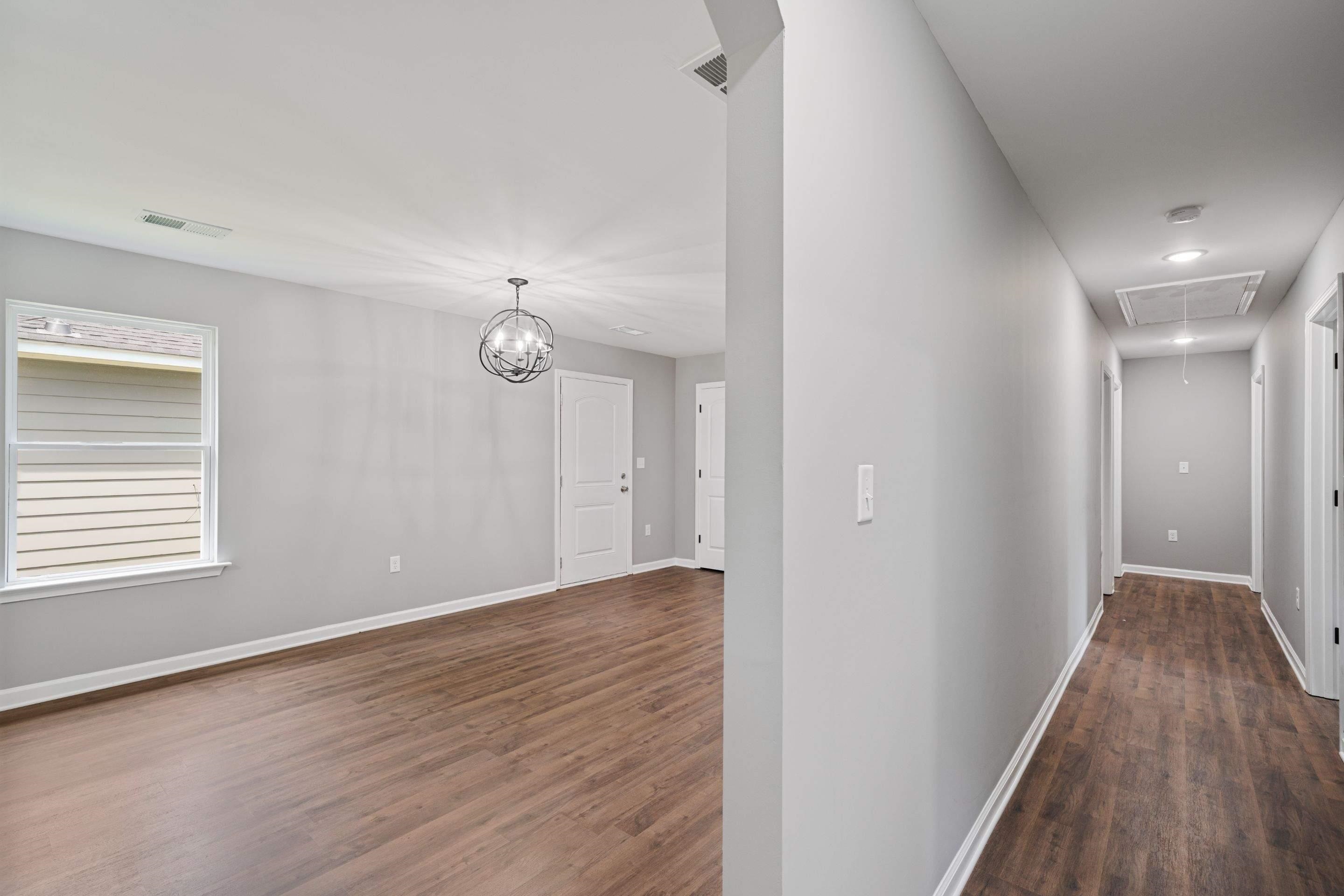 3766 Grey Road Memphis, TN 38108 - Photo 6 of 12 a view of an empty room with wooden floor and a window