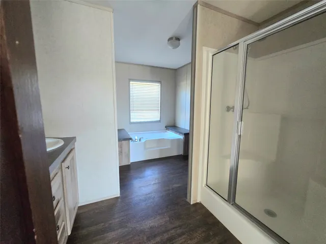 a view of a hallway view with wooden floor and staircase