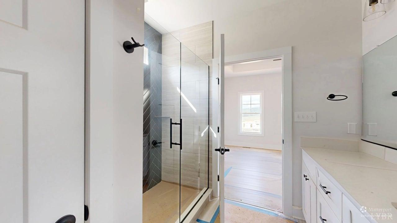 766 Moorman Mill Road Rustburg, VA 24588 - Photo 20 of 42 a bathroom with a glass shower door and a sink