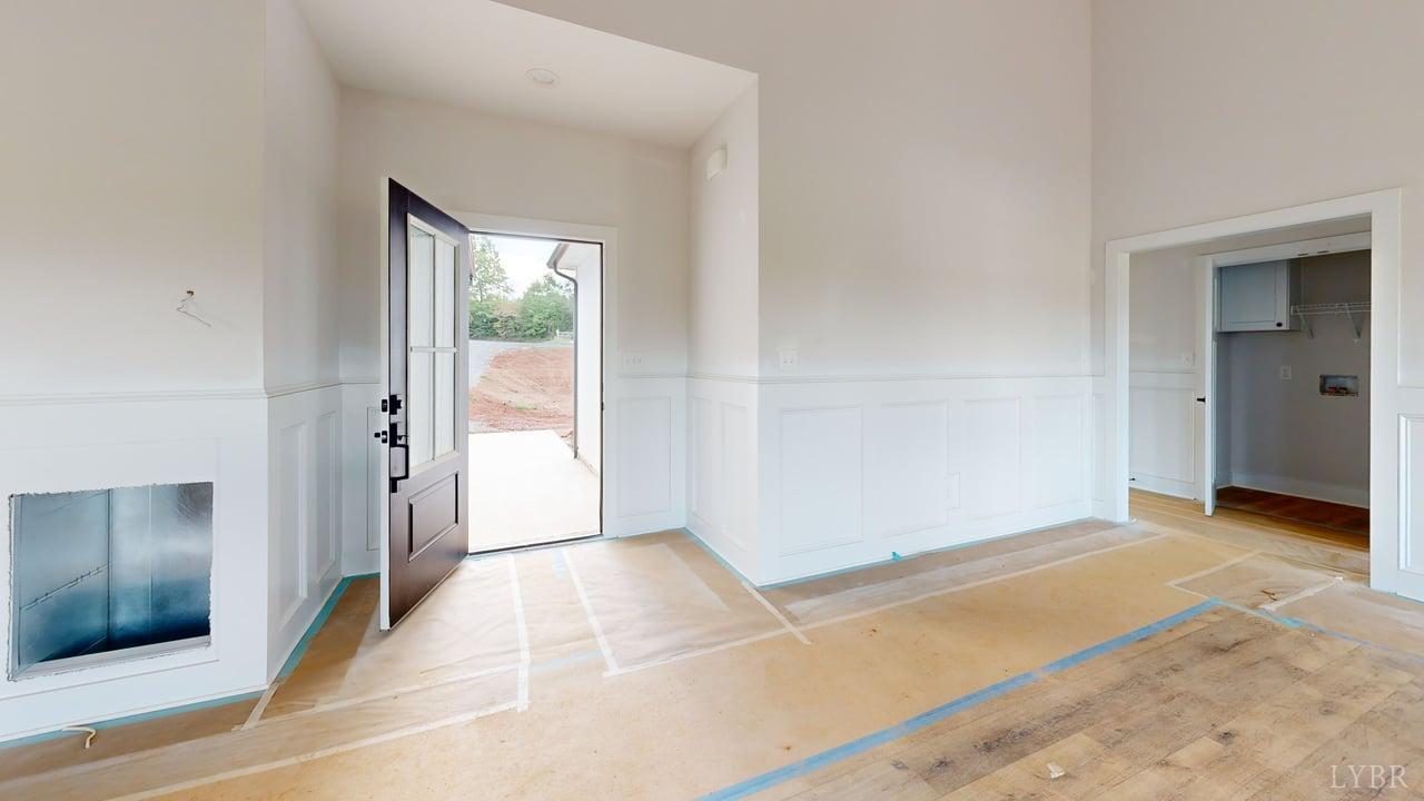 766 Moorman Mill Road Rustburg, VA 24588 - Photo 3 of 42 a view of an empty room with wooden floor and a bathroom