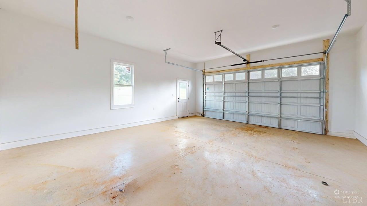 766 Moorman Mill Road Rustburg, VA 24588 - Photo 32 of 42 en empty room with windows and ceiling fan