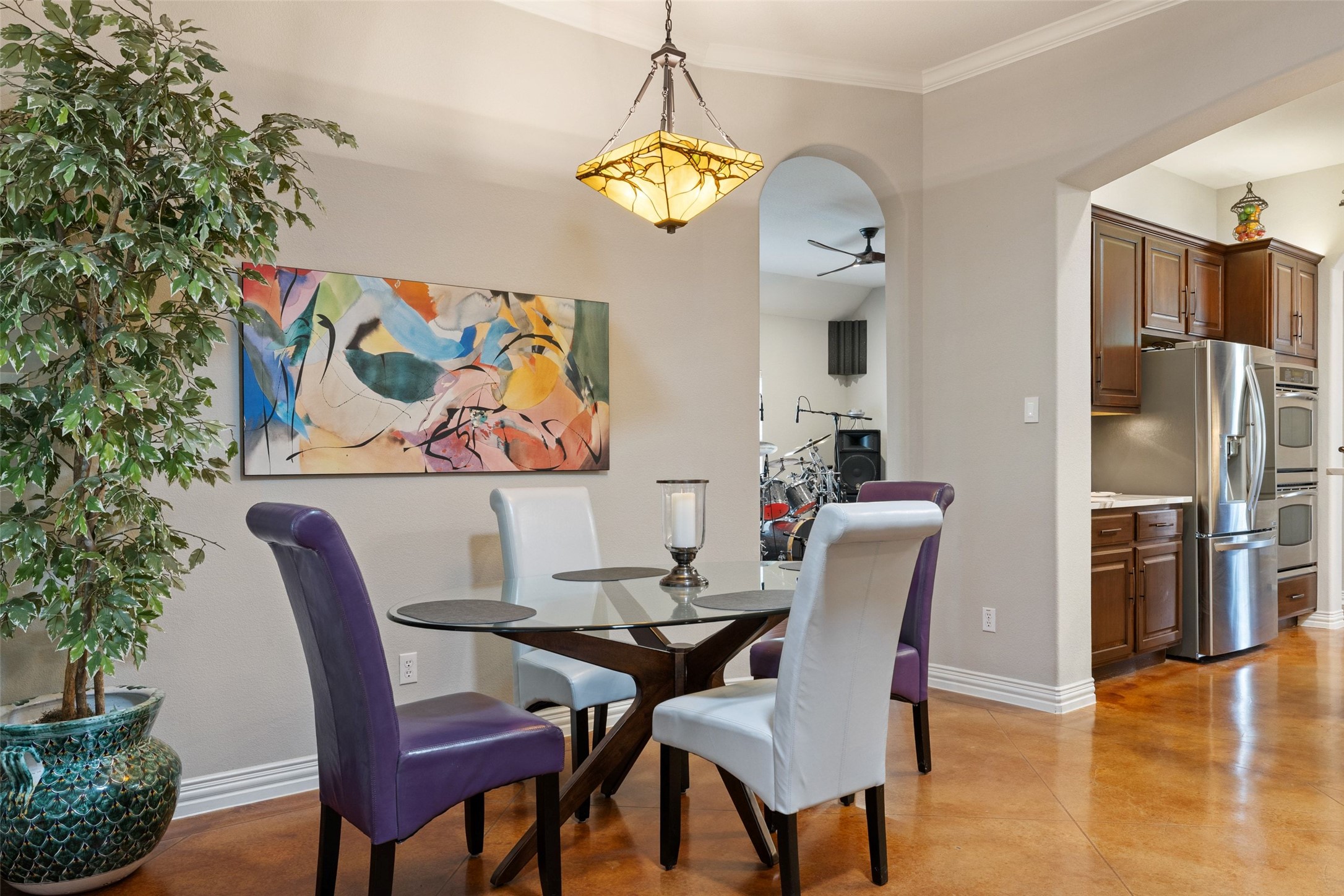 15208 Nightingale Lane Austin, TX 78734 - Photo 18 of 40 Dining area featuring a ceiling fan, concrete floors, and ornamental molding
