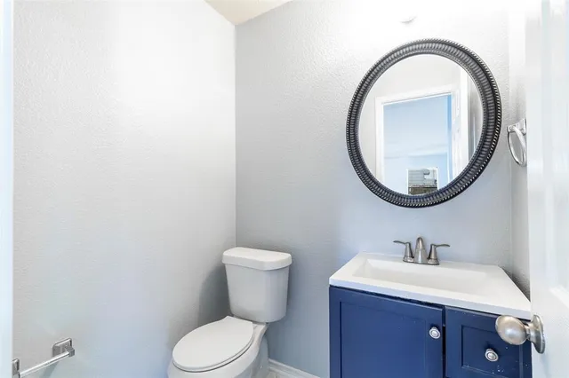a bathroom with a toilet a sink and a mirror
