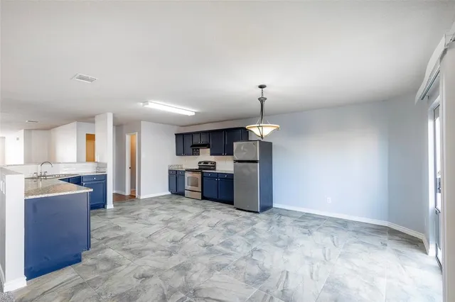 a open kitchen with stainless steel appliances kitchen island a refrigerator sink and stove