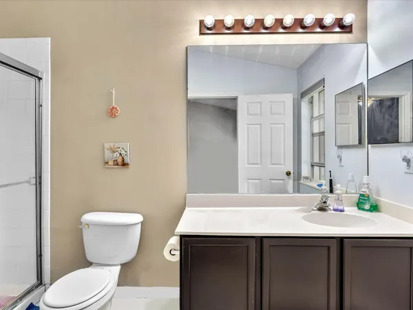 a bathroom with a sink a toilet and mirror