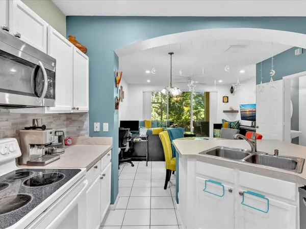 a kitchen filled a sink a counter and appliances