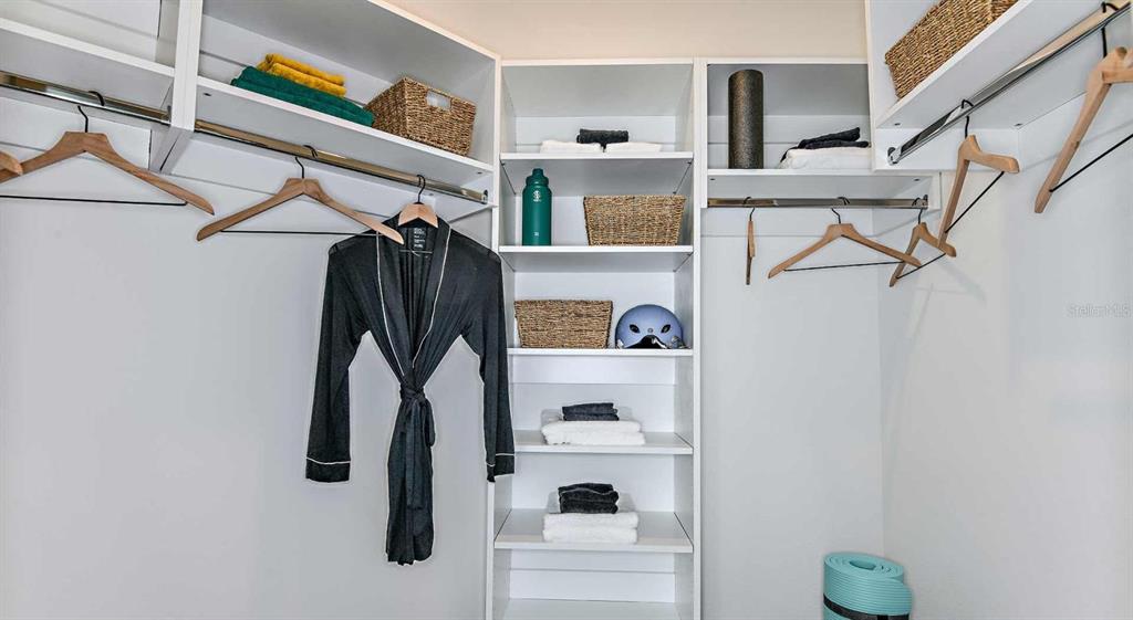 1040 Jamison Loop, Unit REVIVE Kissimmee, FL 34744 - Photo 15 of 18 a view of walk in closet with clothes and shoes