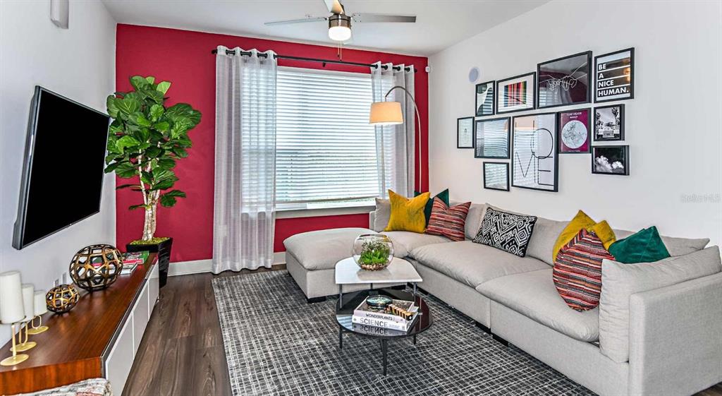 1040 Jamison Loop, Unit REVIVE Kissimmee, FL 34744 - Photo 8 of 18 a living room with furniture potted plant and a window