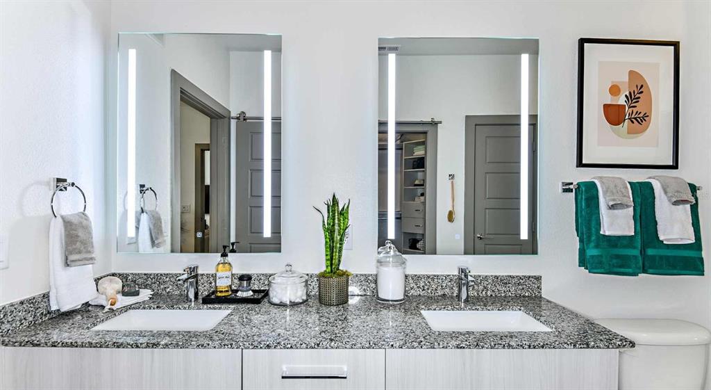 1040 Jamison Loop, Unit REVIVE Kissimmee, FL 34744 - Photo 10 of 18 a bathroom with double vanity sinks and a mirror