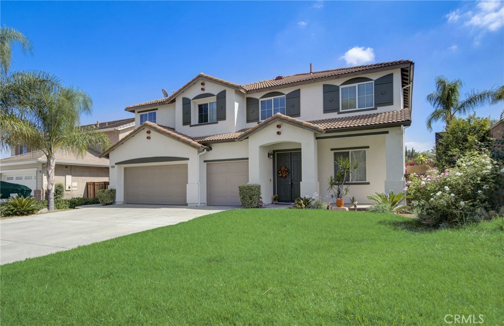 a front view of a house with a yard and garage