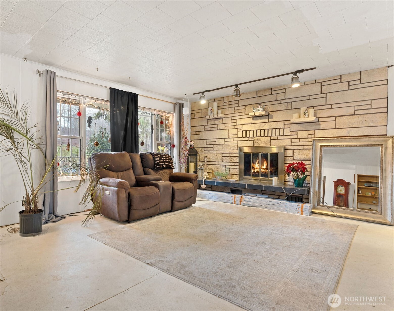 451 Elk Creek Road Chehalis, WA 98532 - Photo 6 of 31 a living room with furniture a fireplace and a flat screen tv