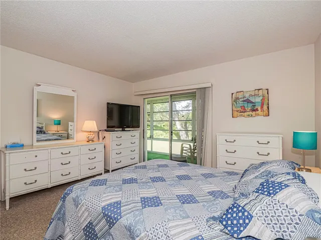 a bedroom with a bed and a dresser in it