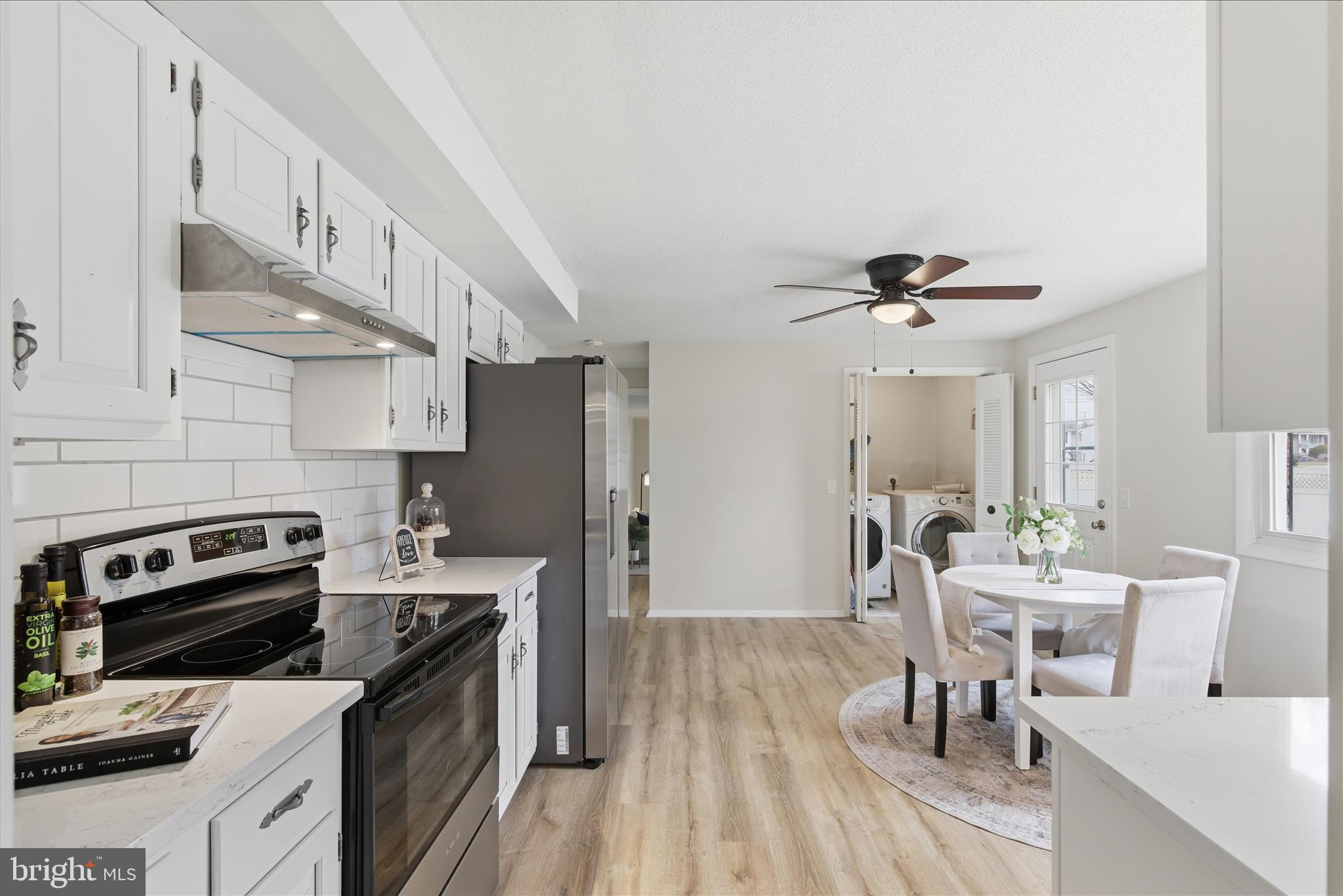 2430 Opal Road York, PA 17408 - Photo 19 of 59 a kitchen with stainless steel appliances a stove a sink dishwasher a refrigerator white cabinets with wooden floor