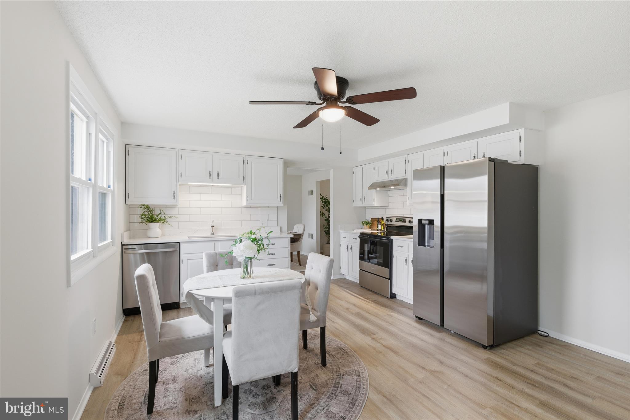 2430 Opal Road York, PA 17408 - Photo 22 of 59 a kitchen with stainless steel appliances a dining table chairs refrigerator and sink