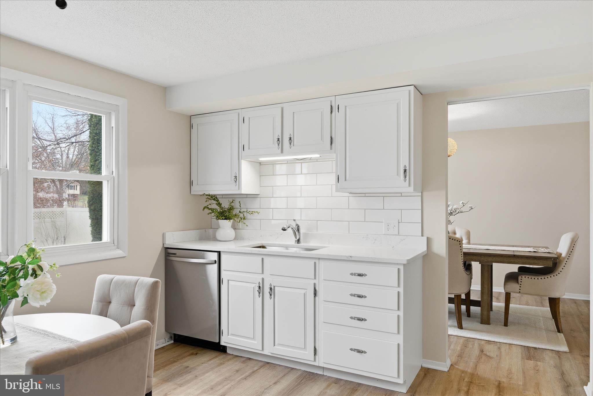 2430 Opal Road York, PA 17408 - Photo 23 of 59 a kitchen with white cabinets a sink a window and white stainless steel appliances