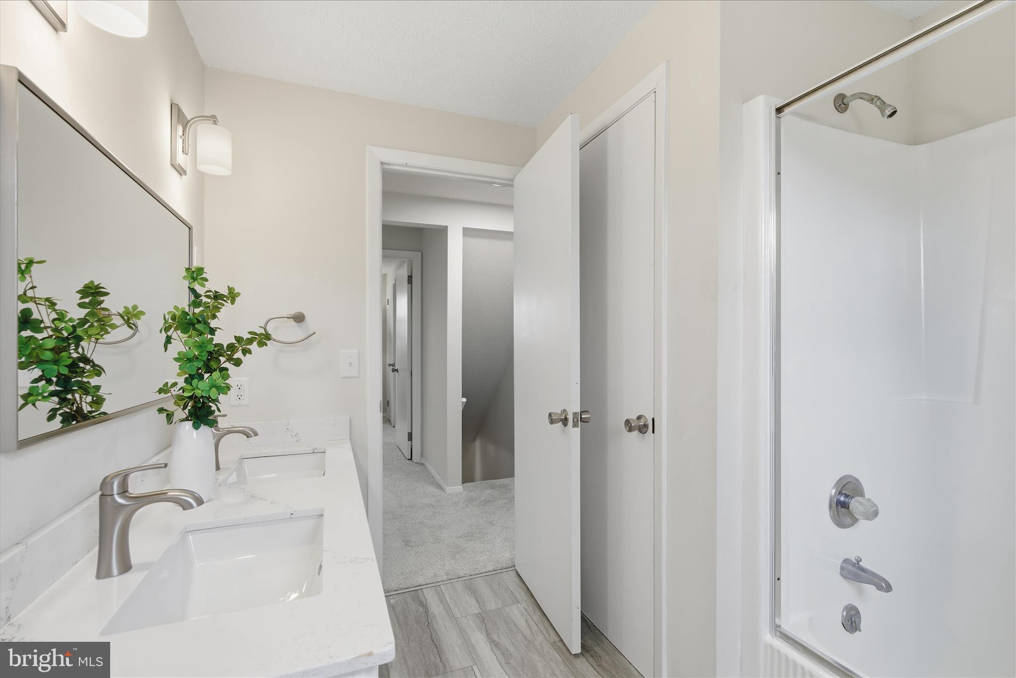 2430 Opal Road York, PA 17408 - Photo 43 of 59 a bathroom with a sink a faucet a potted plant and a mirror