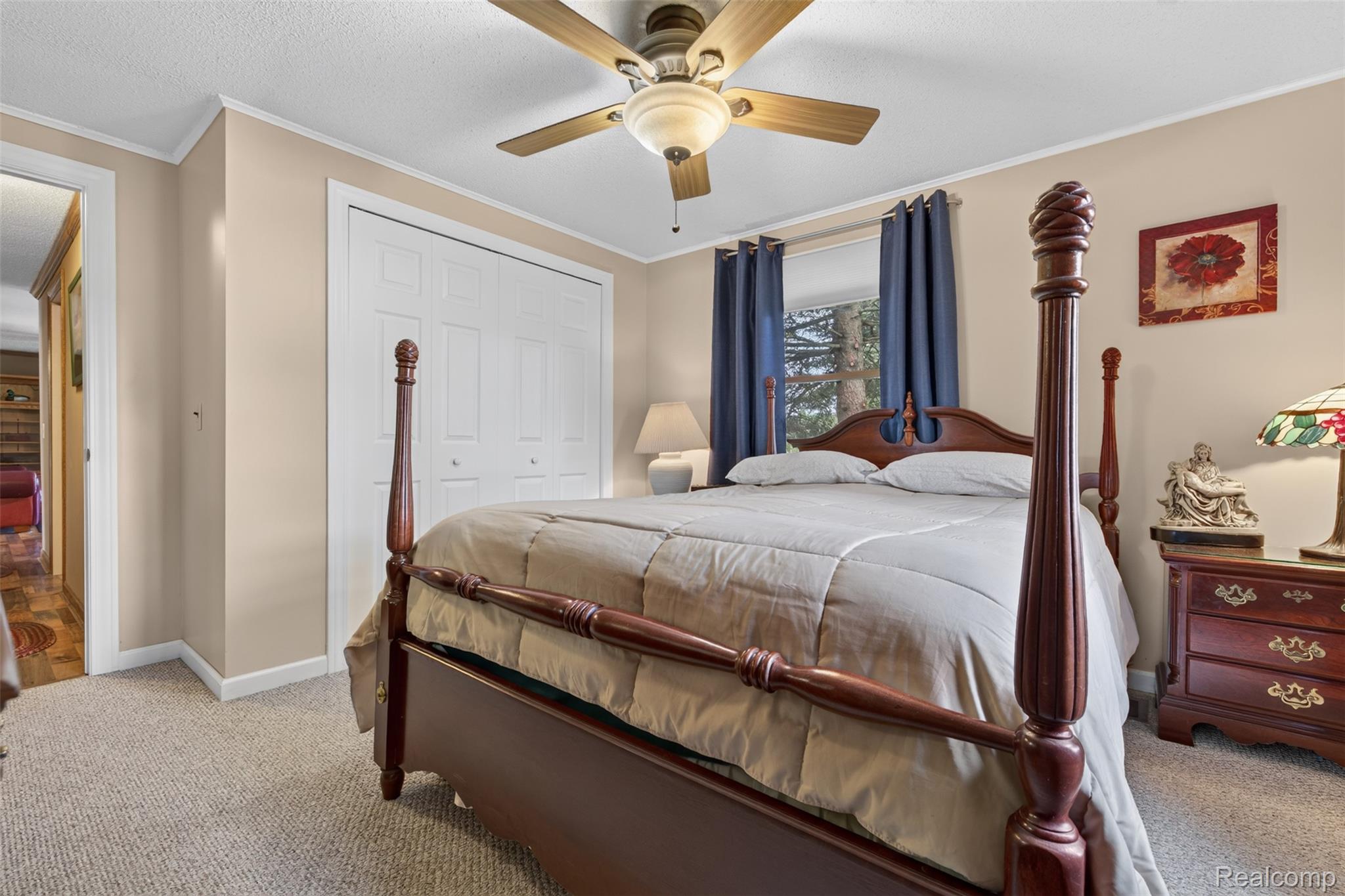 5977 Anglers Road Ortonville, MI 48462 - Photo 19 of 63 Carpeted room featuring a ceiling fan, window with exterior tree views, and bi-fold closet doors