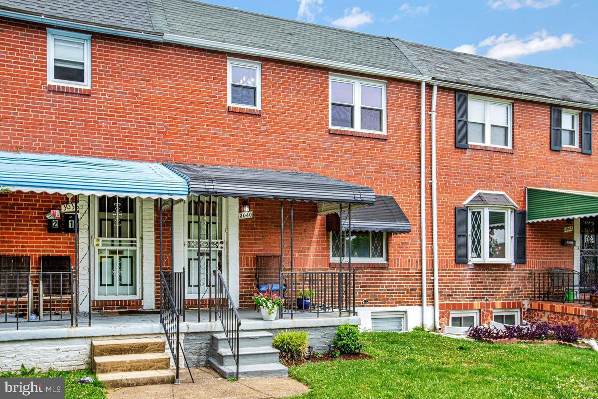 3040 Federal Street Baltimore, MD 21213 - Photo 3 of 41 front view of brick house with a yard