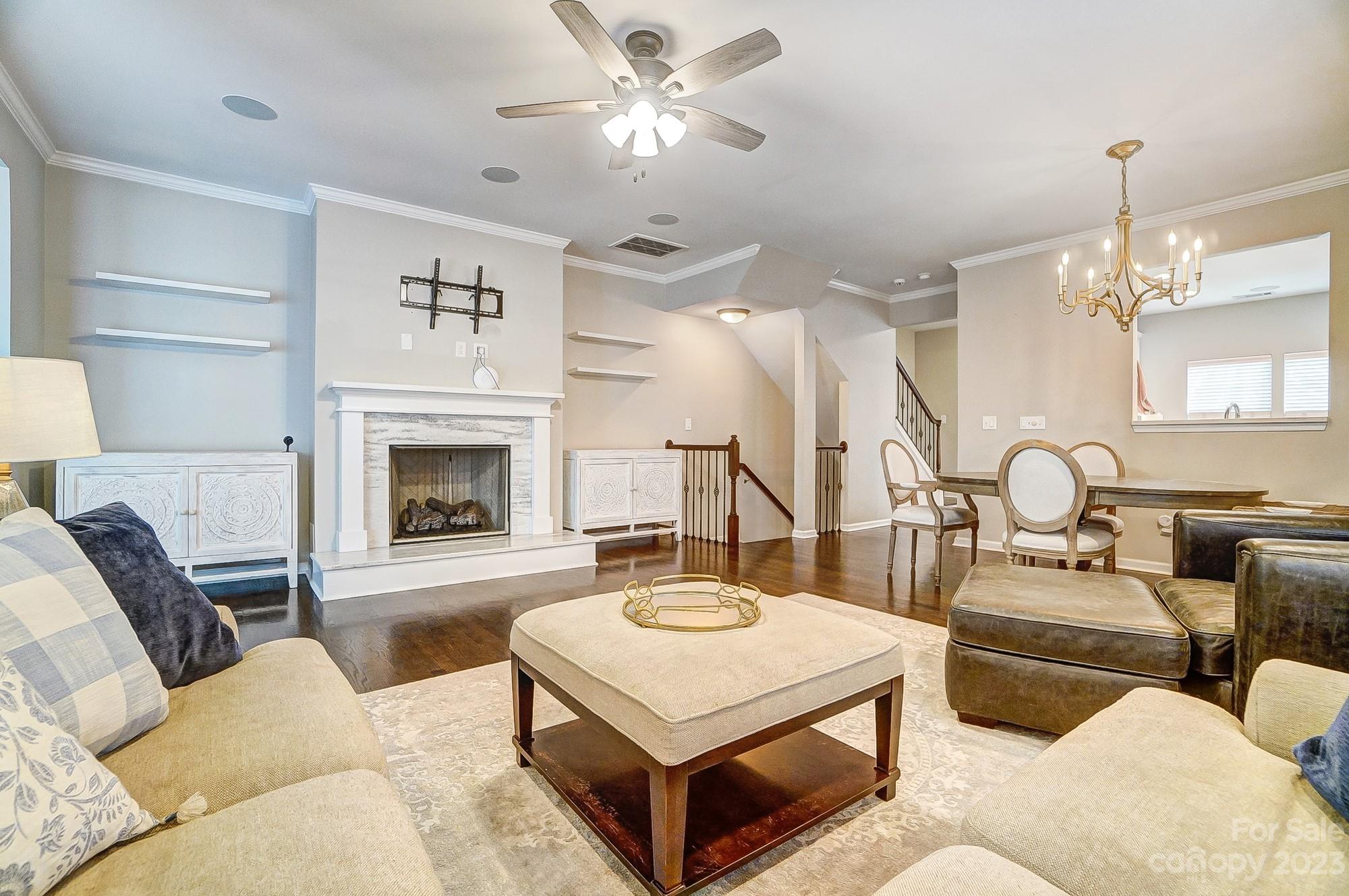 231 Lincoln Street Charlotte, NC 28203 - Photo 18 of 48 a living room with furniture a fireplace and a chandelier